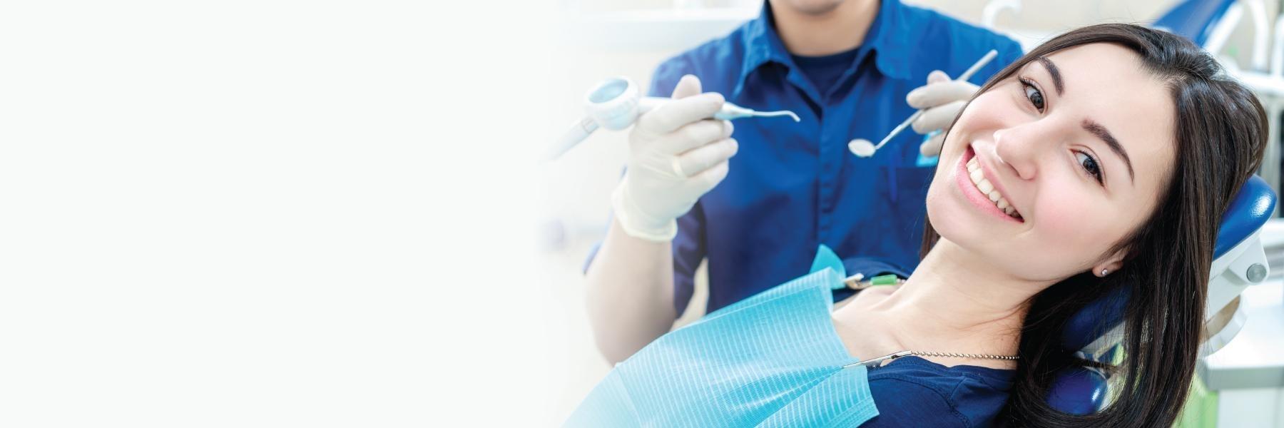 Woman sitting in dental chair during cleaning in Roanoke